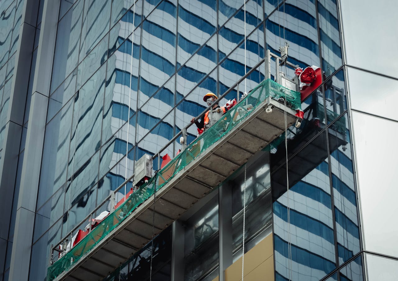 services-01 Urban worker cleaning windows on a high-rise in Ho Chi Minh City, Vietnam.